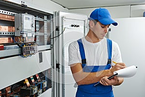 electrician worker inspecting equipment and electricity meter