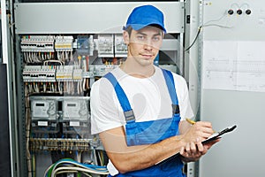 electrician worker inspecting equipment and electricity meter