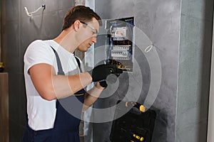 Electrician worker at work on an electrical panel