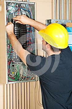 Electrician Working on Electrical Panel photo