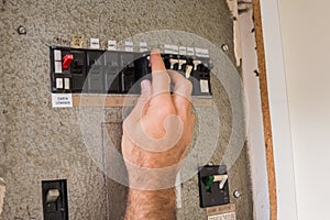 Electrician working on the fuse box