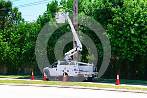 Electrician working on high power lines in a lift