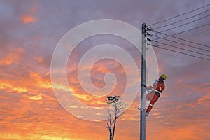 An electrician is working on a pole.Linemen