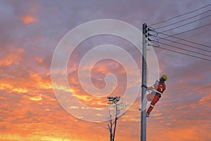 An electrician is working on a pole.Linemen photo