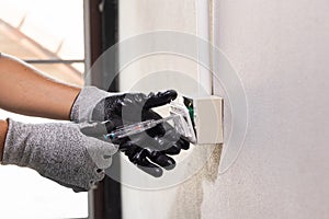Electrician working safely on sockets of a residential electrical system