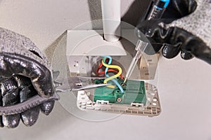 Electrician working safely on sockets of a residential electrical system