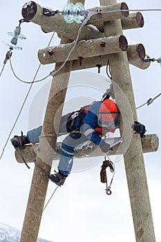 Electrician working on top of an electricity pylon