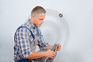 Electrician working with wire with plier