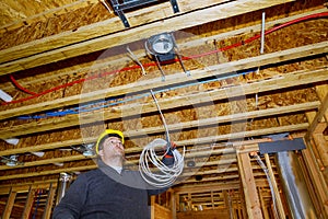 Electrician working with wires in new home