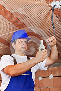 Electrician working with wiring in a new building