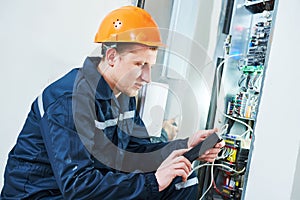 Electrician works with electronic equipment