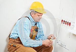 Electricians at cable wiring work