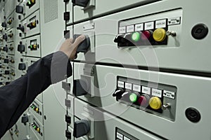 Electricians are checking electrical control panels in industrial plants