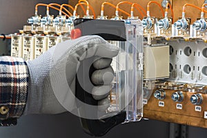 Electricians hand installs breakers in an electrical switchboard