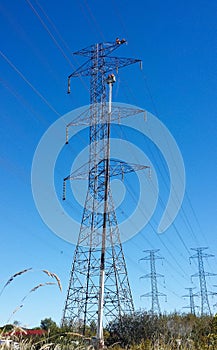 Electricians repair high-voltage wires on top of transmission tower