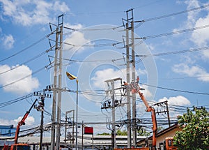 Electricians is repairing high voltage wires on electric power pole