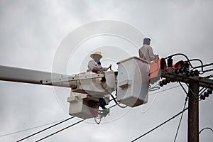 electricians repairing wire of the power line on electric power