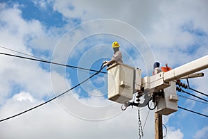 electricians repairing wire of the power line on electric power