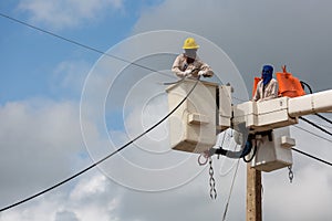 electricians repairing wire of the power line on electric power