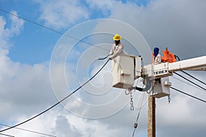 Electricians repairing wire of the power line on electric power