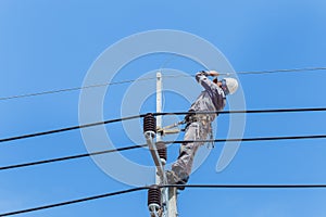 Electricians Wiring Cable repair services,worker in crane truck bucket fixes high voltage power transmission line,setting up the
