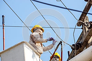 Electricians working on cable car to repair the power line