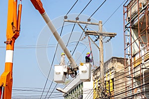 Electricians working on cable car to repair the power line