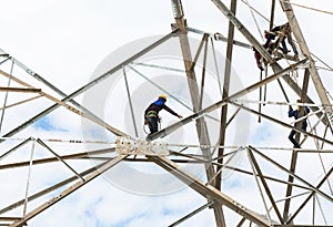 Electricians working on pylon construction tower