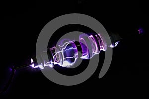 Electricity arcing over ceramic insulator surface photo