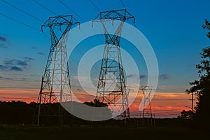 Electricity cable communication towers on sunset stretching