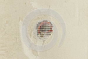 Electricity cable in hole in plastered wall. Construction of house and home renovation concept. Cabling