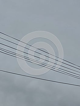 electricity cable over a cloudy sky