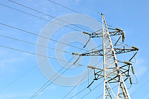 Electricity concept, high voltage power lines. High voltage electric transmission pylon silhouetted tower. Wire electrical energy