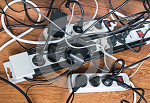 Electricity consumption concept. Many cables of electrical home appliances. photo