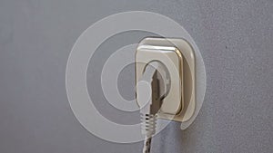 Electricity consumption - plugging power plugs into wall outlet. Time lapse