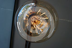 Electricity current inside a retro crystal clear light bulb.