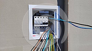 electricity distribution box with wires and circuit breakers