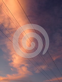 Electricity distribution station.Silhouette high voltage electric towers at sunset time. High-voltage power lines. Only wire