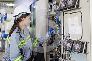 electricity engineer female working check service high voltage electrical cabinet. worker repair electric surge problem problem in