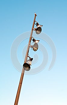 Electricity flood lights with a seagull sat on top