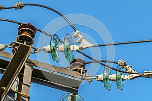 Electricity garlands of insulators with electric wires on a top steel mast