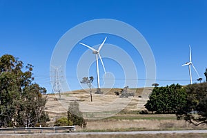 Electricity generating windmill Farms Hume Highway NSW Australia taken from moving car blurred foreground