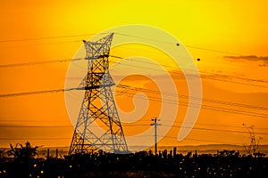 Electricity lines against a radiant sunset in rural Kenya