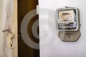 Electricity meter on a white wall. A device for measuring the consumption of electric current