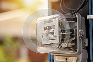 Electricity meters for home electrical appliances, including blurred natural green backgrounds. photo