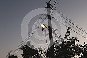 Electricity pole with street lights at night