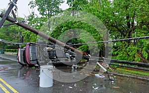 Electricity poles fall because of storms. damaged car