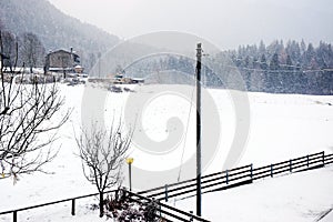 Electricity poles, landscape, winter in Dolomiti mountains, in Cadore, Italy