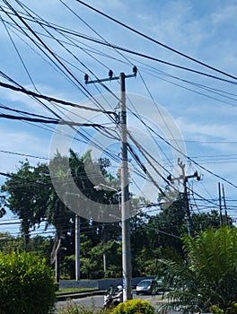 electricity poles with lots of screeching cables