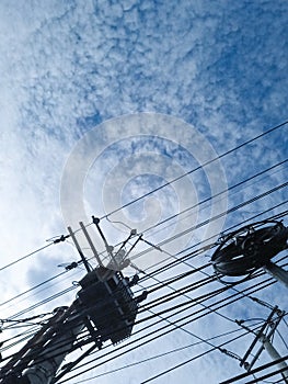 electricity poles with twisted wires in the morning